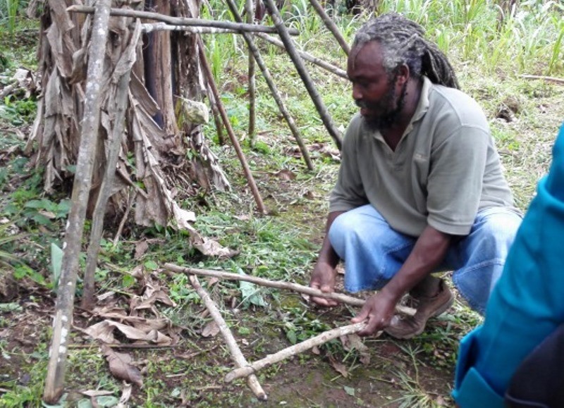 Farmer demonstrating the use of an A frame