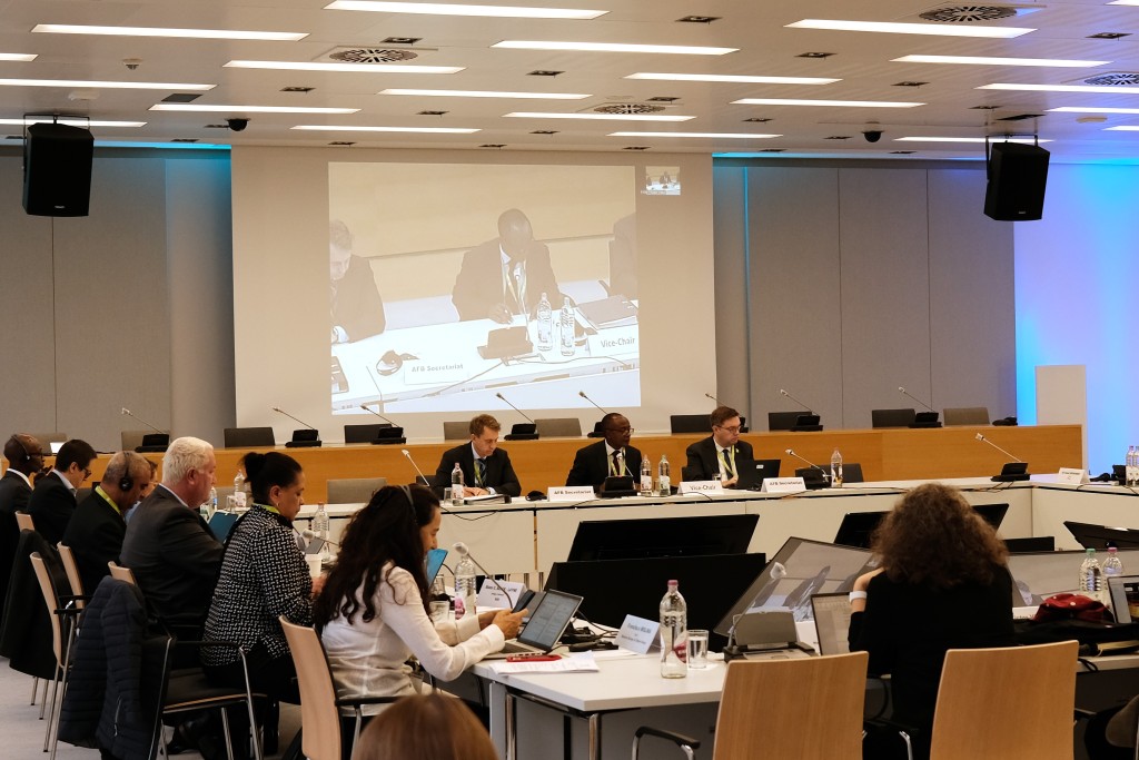 A group of professionals sit around a conference table.